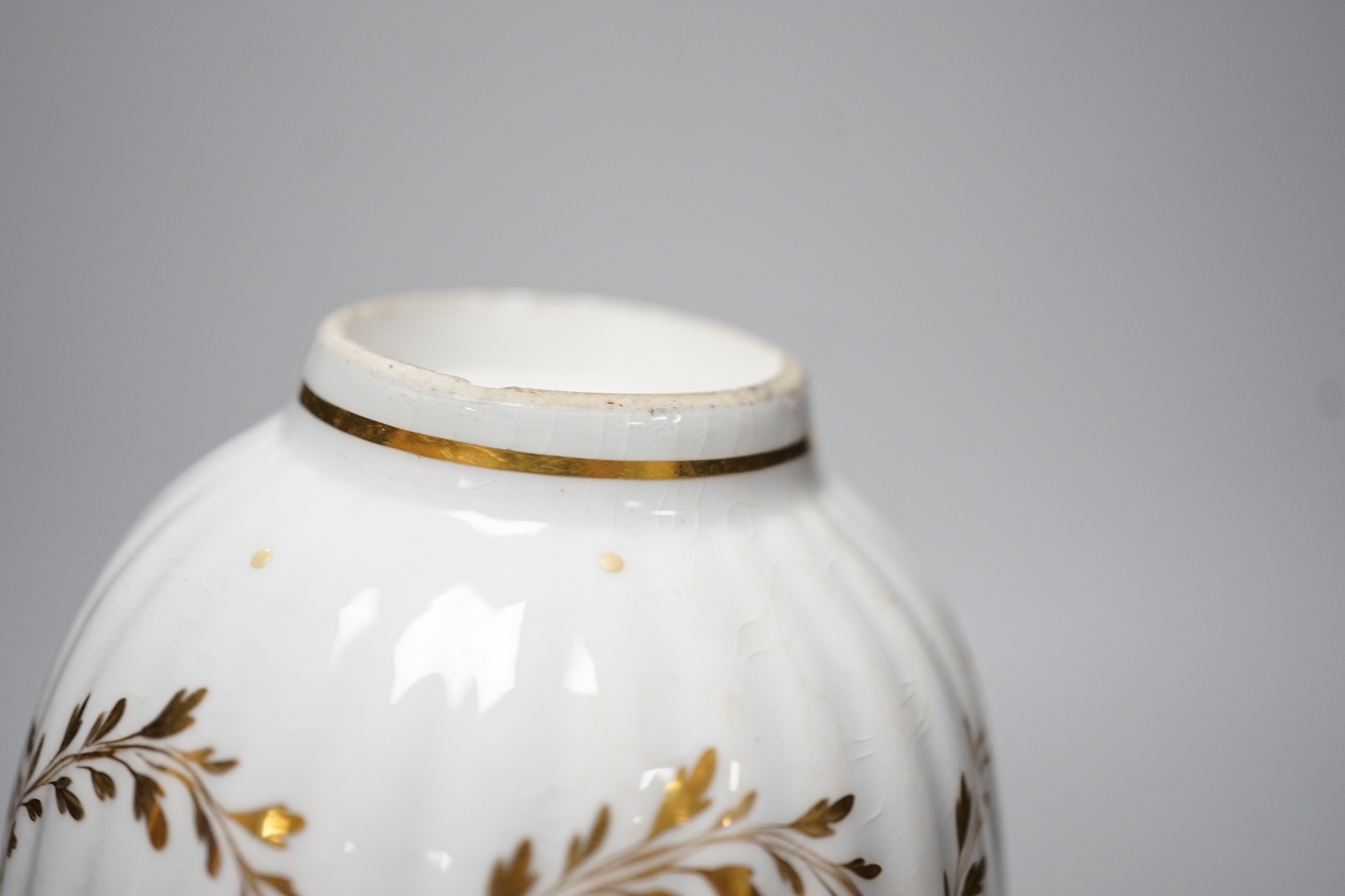 An 18th century Caughley rare teabowl and saucer painted with a crest of an arm clutching a dragon encircled by three gilt borders, 6cm tall overall